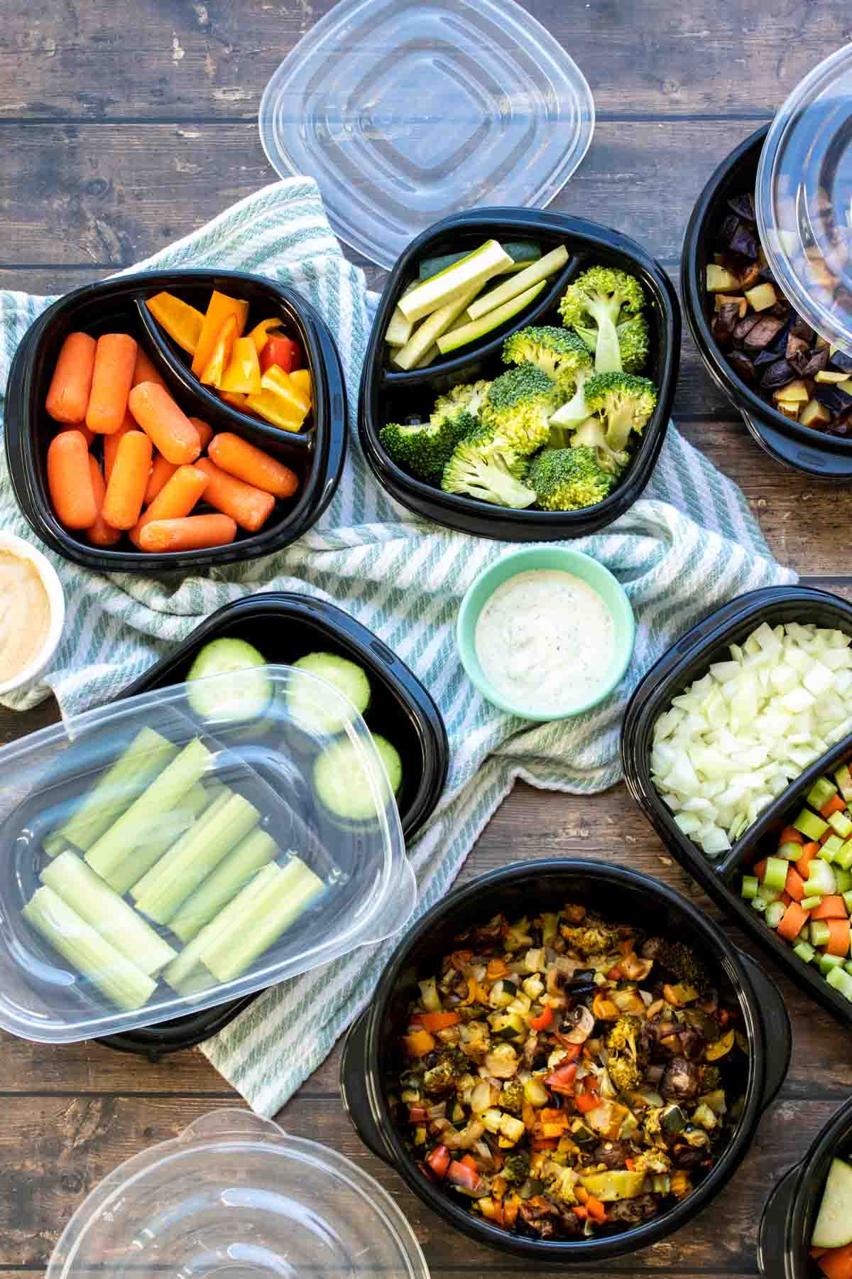 Meal planning containers filled with fresh healthy vegetables